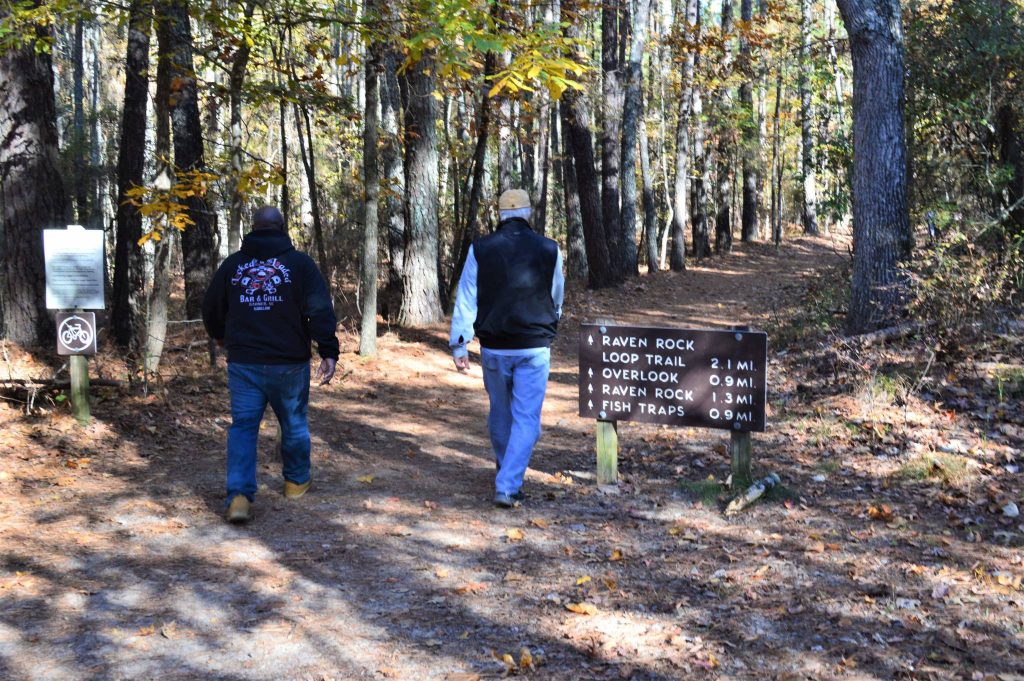 trail sign and hikers at Raven Rock State Park