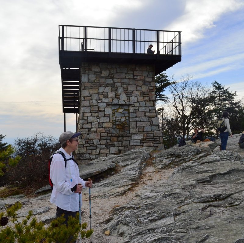 Woman and other people and observation tower atop Moore's Knob in Hanging Rock State Park, Danbury, North Carolina
