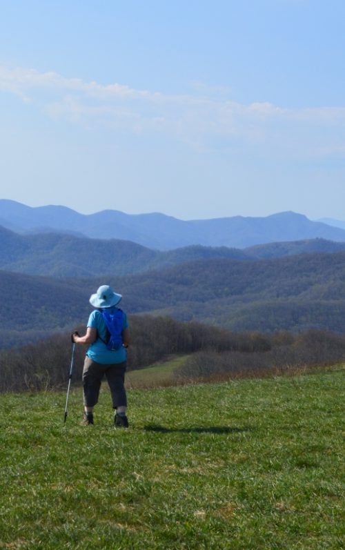 Woman on grassy bald at Max Patch in the Pisgah National Forest in North Carolina