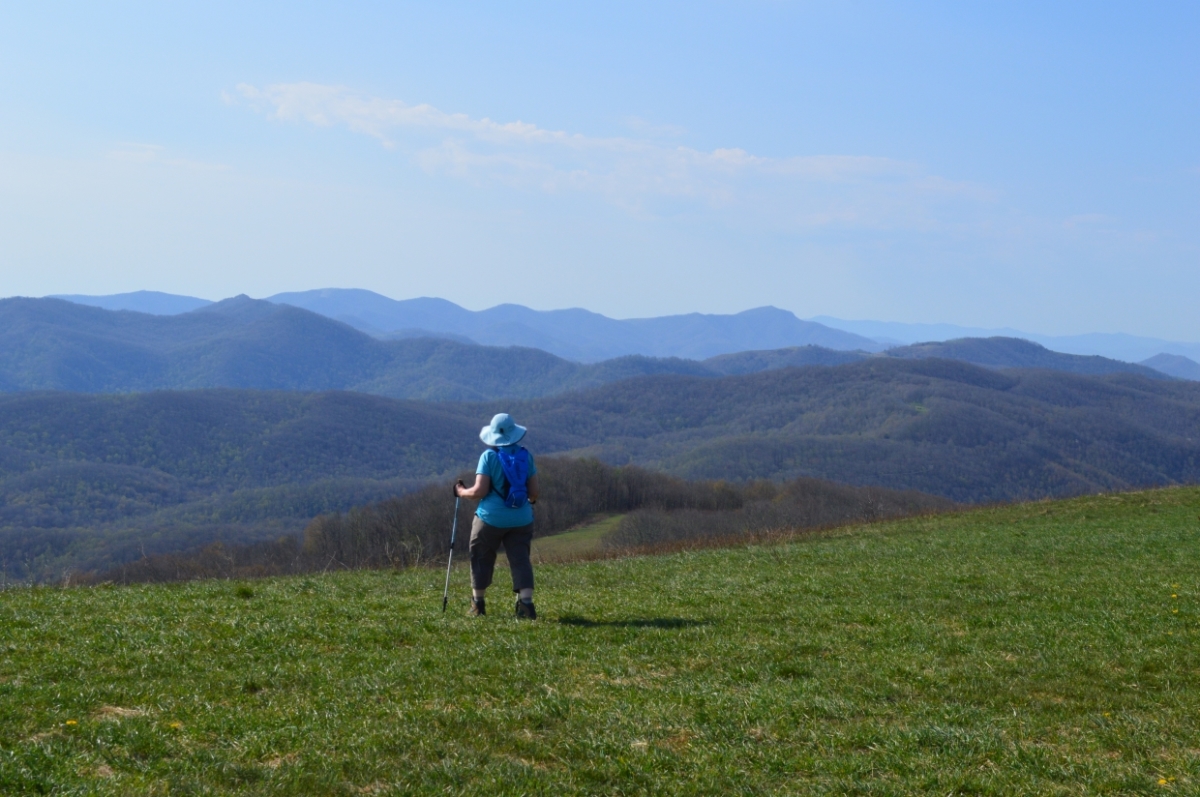 Woman on grassy bald at Max Patch in the Pisgah National Forest in North Carolina