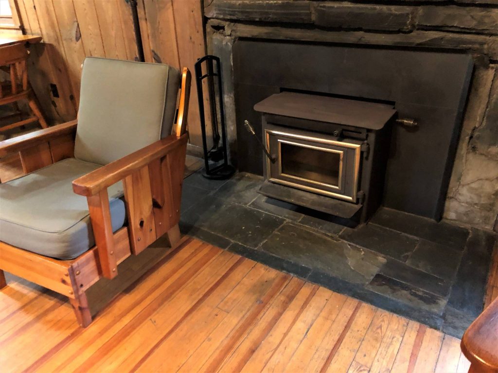 Cabin fireplace and chair at Morrow Mountain State Park