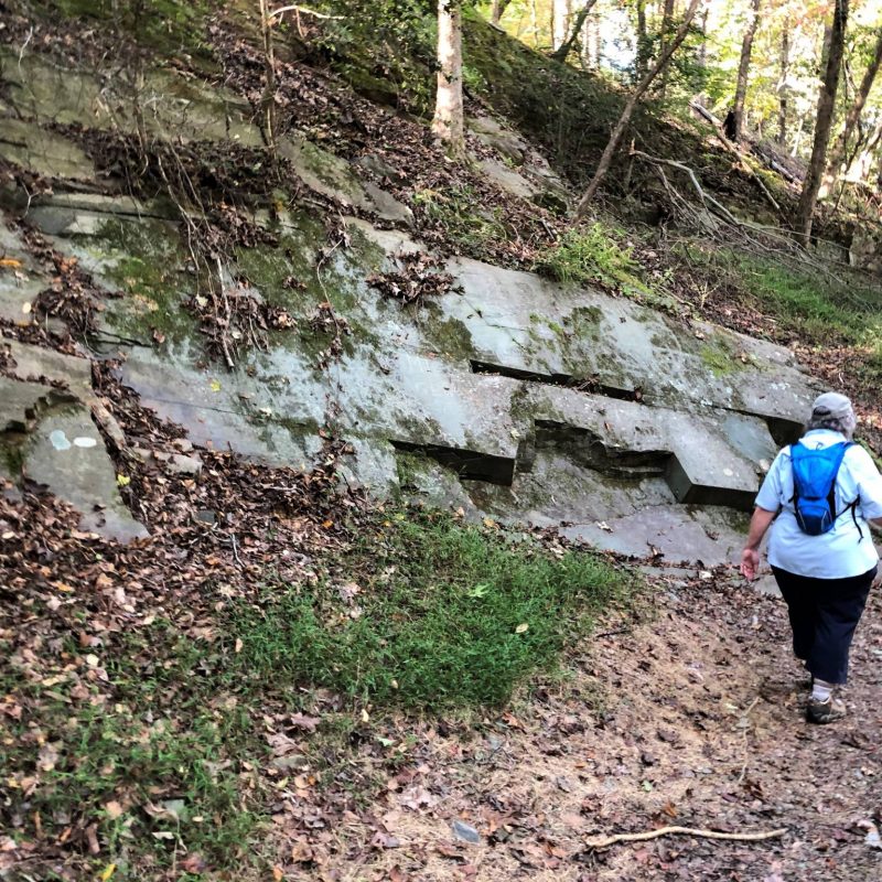 hiker and exposed rock of quarry at Morrow Mountain State Park