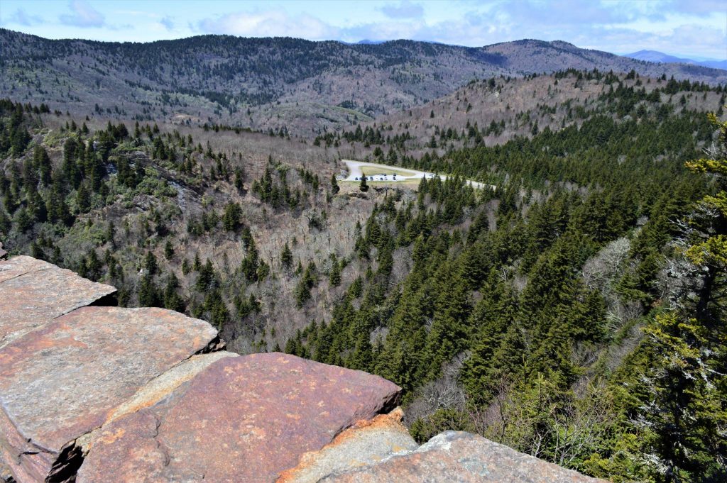 depicting view from top of devil's courthouse, blue ridge parkway, to parking lot below