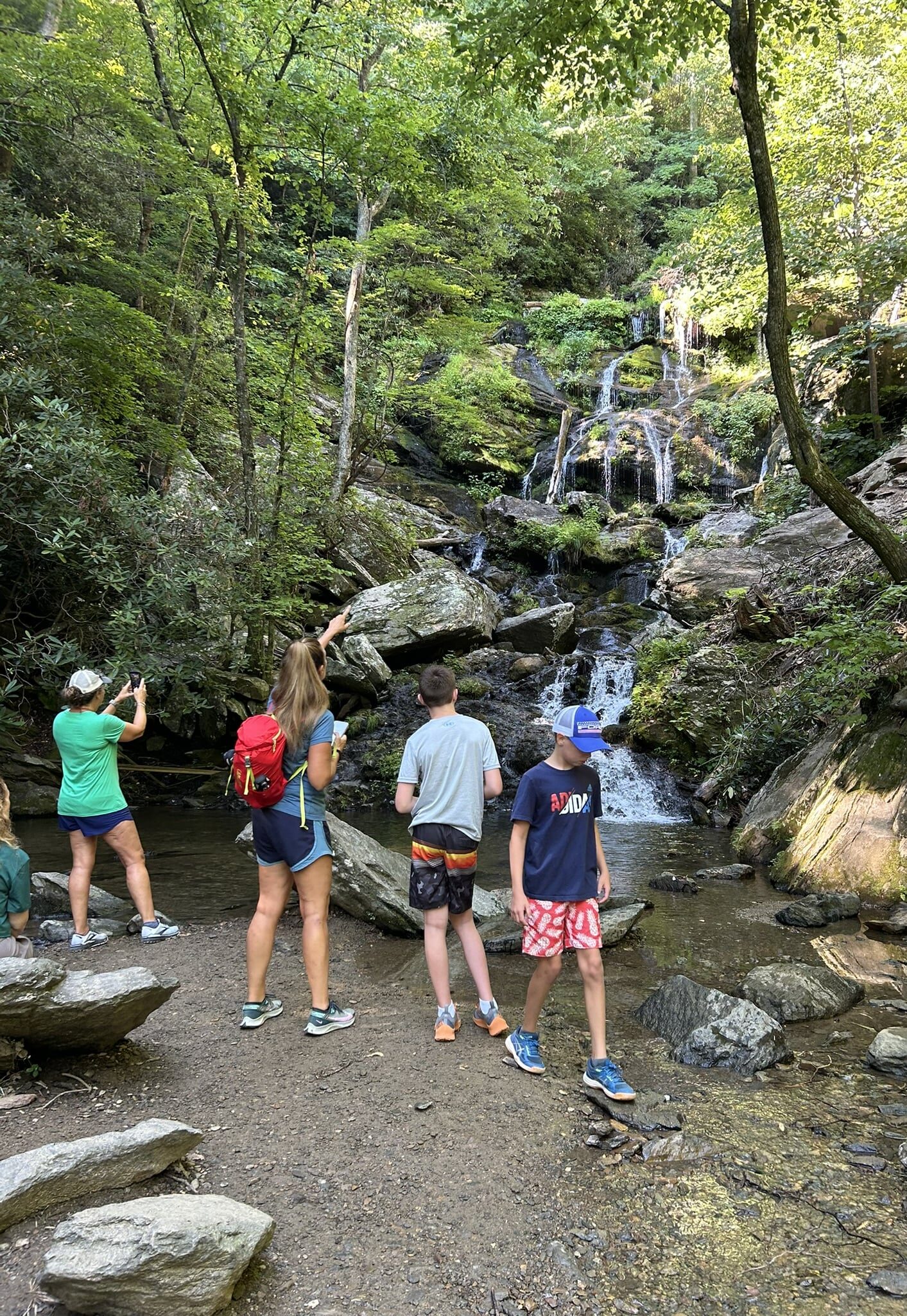 people at basepfwaterfall in forest